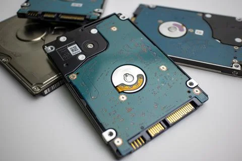 Stack of internal laptop hard drives in a pile front connections 스톡 사진
