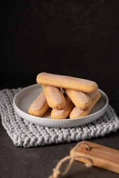 Stack of Italian Ladyfinger Biscuits on a White Ceramic Plate 스톡 사진