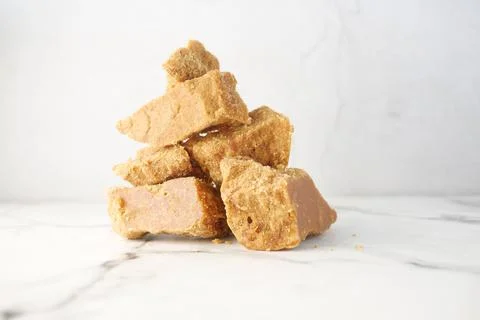 Stack of Jaggery traditional cane sugar cube on table Stock Photos
