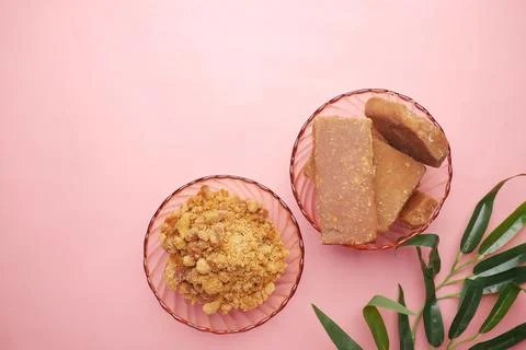 Stack of Jaggery traditional cane sugar cube on pink Stock Photos