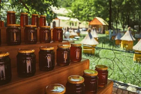 Stack of jars with honey by apiary Fotos de archivo