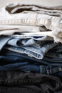 Stack of jeans. Denim jeans texture or denim jeans background, close-up. Vert Stock Photos