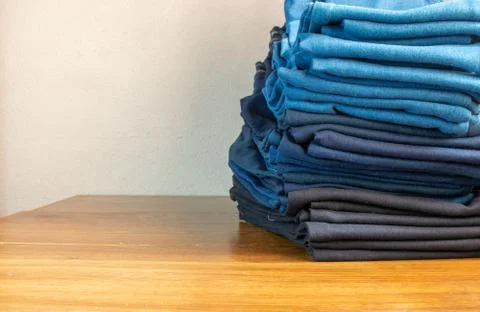 Stack of jeans of different colors Photos