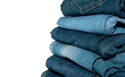 A stack of jeans in different colors on a white background. Jeans isolate Stock Photos