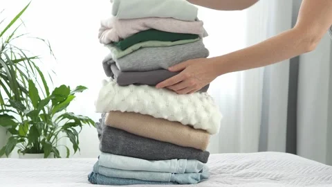 A stack of jeans, sweaters with a label for recycling. Clothes for recycling. cl Stock Footage 281340496