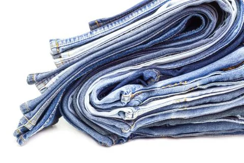 Stack of jeans on white background. Stock Photos