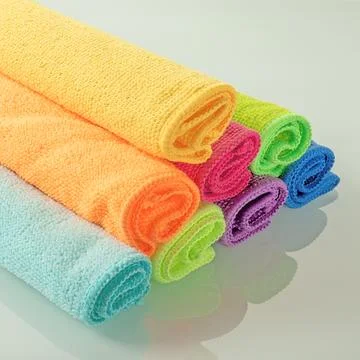 Stack of kitchen microfiber towels in bright colors on a light mirror background Stock Photos