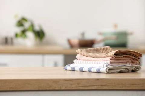 Stack of kitchen towels on wooden countertop Stock Photos