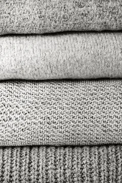 Stack of knit sweaters color of 2026 year cloud white Stock Photos