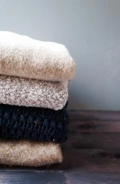 Stack of knitted and woolen winter clothes Stock Photos