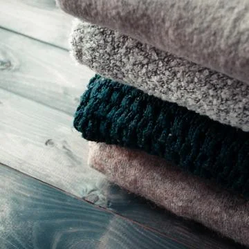 Stack of knitted and woolen winter clothes Stock Photos