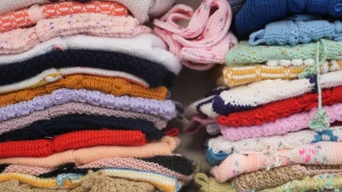 Stack of knitted warm sweaters with different knitting patterns. Stock Footage 259257745