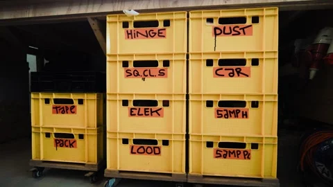 Stack of labeled storage crates used for sorting tools and materials in a Stock Footage 334996274