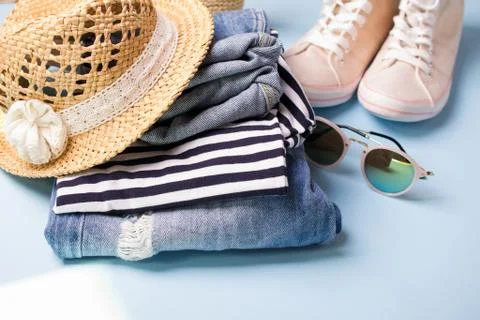 Stack of ladies summer clothes  and accessories.  Jeans overalls, glasses, Stock Photos