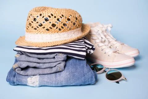 Stack of ladies summer clothes  and accessories.  Jeans overalls, glasses, Stock Photos