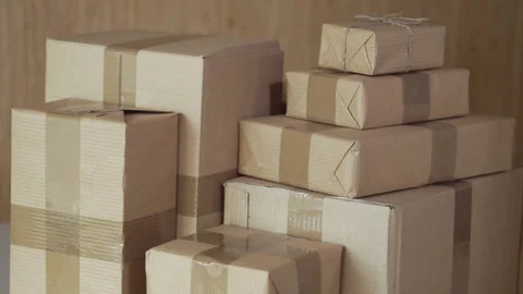 A stack of large and small postal parcels on the table Stock Footage 96213938