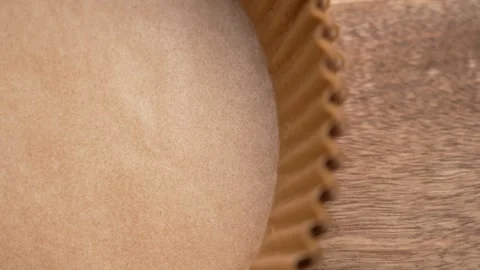 Stack of large brown paper molds. Wooden background Stock Footage 300191064