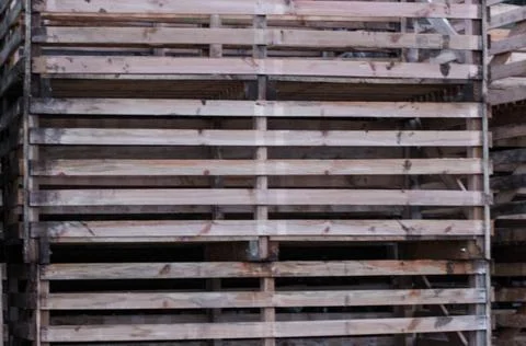 A stack of large, weathered wooden crates or bins with slatted sides. The par Stock Photos