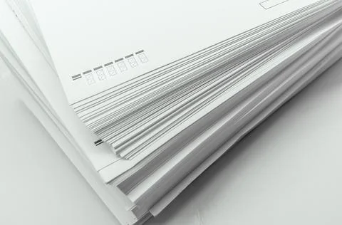 A stack of large white postal envelopes. Packaging for letters and documents Stock Photos