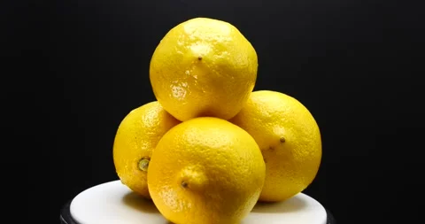 Stack of lemons fresh fruit rotating isolated on black close up Stock Footage 205435114