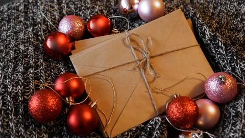 Stack of letters from craft paper with christmas red and pink balls 스톡 사진