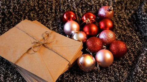 Stack of letters from craft paper with christmas red and pink balls 스톡 사진