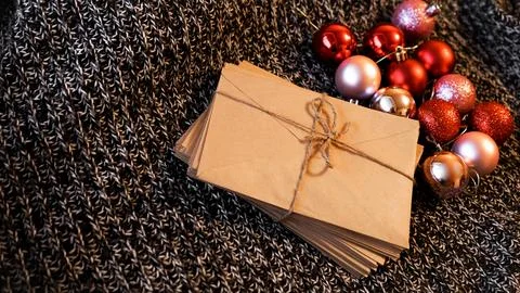 Stack of letters from craft paper with christmas red and pink balls Stock Photos