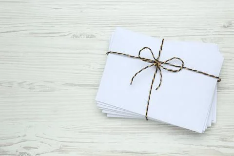 Stack of letters tied with string on white wooden table, top view. Space for  스톡 사진
