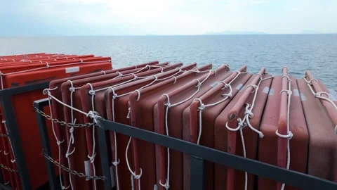 A stack of life rafts overlooking the ocean, ready to be deployed in the water Video stock 264744202
