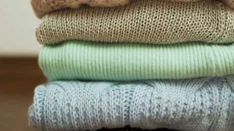 Stack Lots of Cozy Warm Woolen Winter Sweaters Plaids Clothes Bedspreads Close-u Stock Footage 220706304