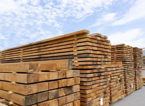 Stack of lumber and planks in a lumber warehouse outdoors Stock Photos