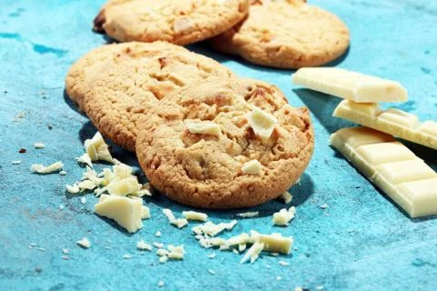 Stack of macadamia nut and white chocolate cookies on table with chocolate ch Stock Photos