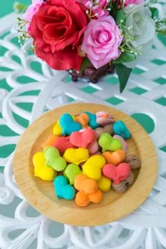 Stack of macaron heart shape dessert  on woodent plate Stock Photos