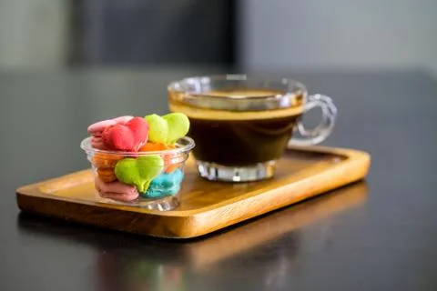 Stack of macaron heart shape dessert with coffee cup on woodent plate Stock Photos