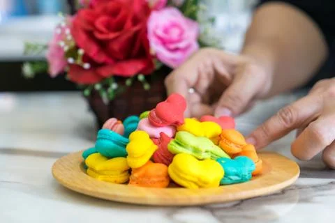 Stack of macaron heart shape dessert  on woodent plate Stock Photos