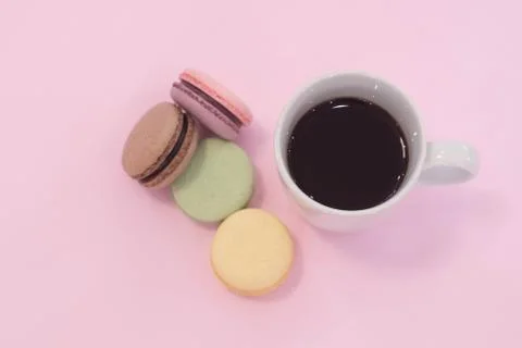 Stack of macarons with coffee cup. on pink background. Stock Photos
