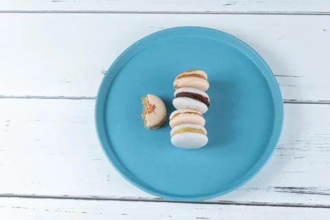 Stack of macarons with dulce de leche filling and chocolate ganache next to a Stock Photos