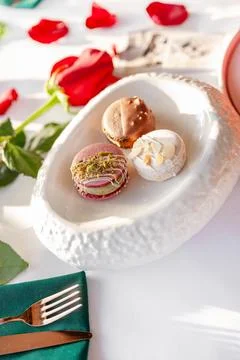 A stack of macarons. Spring composition of macarons with flowers. Stock Photos
