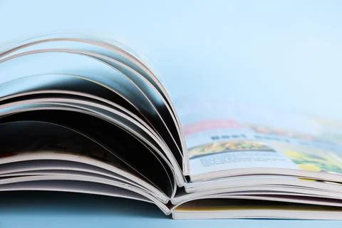 Stack of magazines on light blue background, closeup Foto stock