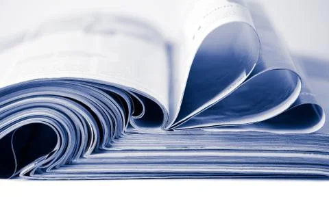 Stack of magazines toned blue isolated Stock Photos
