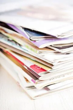 Stack of magazines on white table Stock-Fotos
