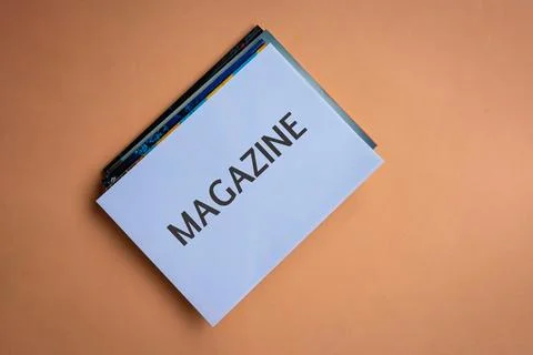Stack of magazines with word Magazine on white cover. Stock Photos