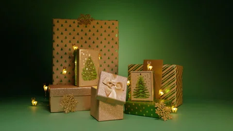 Stack magical gift boxes with green Christmas trees patterns on green background Stock Footage 251374251