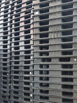 Stack of many black Plastic shipping Pallets Stock Photos