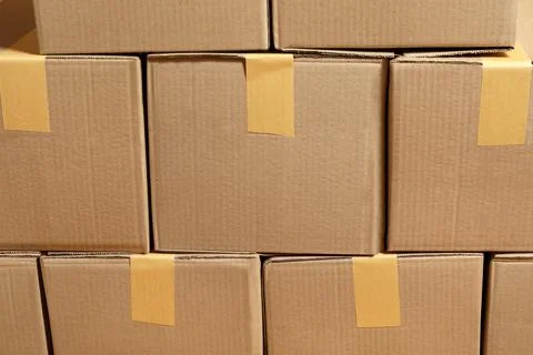 Stack of many cardboard boxes as background. Packaging goods Stock Photos