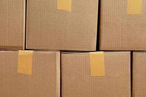 Stack of many cardboard boxes as background. Packaging goods Stock Photos