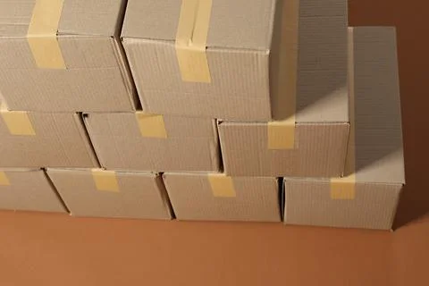 Stack of many cardboard boxes on brown background, above view Stock Photos
