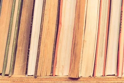 Stack of many old books on shelf in book store. Stock Photos