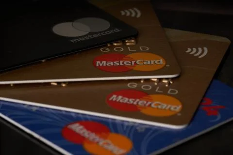 Stack of mastercard cards on black surface Stock Photos