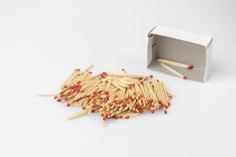 Stack of matches in front of almost empty box white background Foto stock